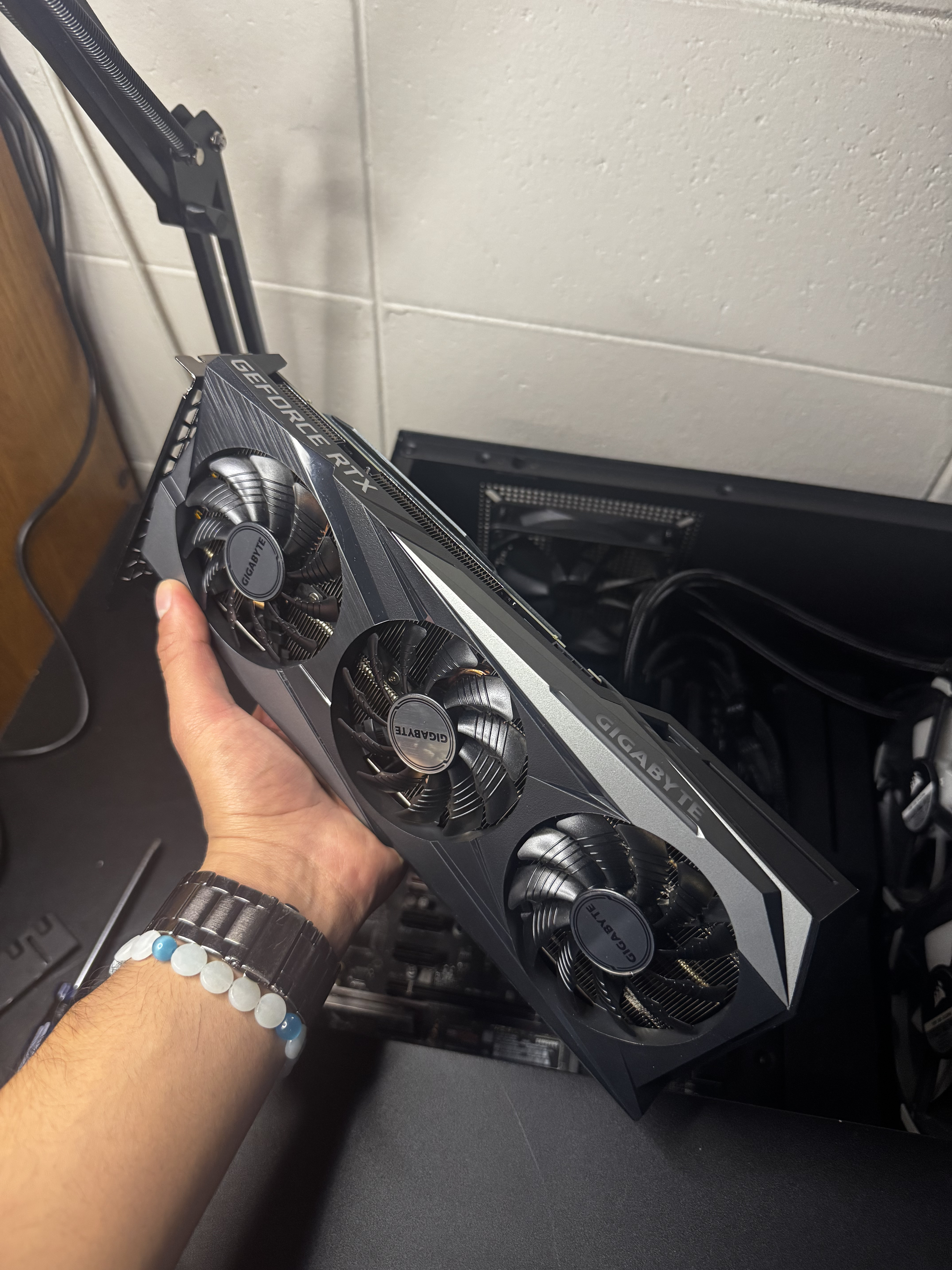 Graphics card being held during a hardware upgrade